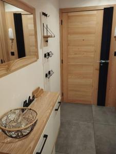 a kitchen with a wooden counter and a door at Magnifique Apt à deux pas du lac et près du centre in Annecy +46 photos