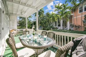 an outdoor patio with a table and chairs at Coral Palm by AvantStay Key West Walkable Gated Community Shared Pool Month Long Stays Only in Stock Island