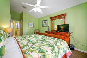 a bedroom with a bed and a mirror and a television at Coral Palm by AvantStay Key West Walkable Gated Community Shared Pool Month Long Stays Only in Stock Island