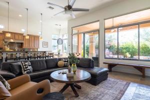 a living room with a couch and a pool table at Sandflower by AvantStay Oasis w Pool Golf in Phoenix