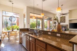 a kitchen with a sink and a counter top at Sandflower by AvantStay Oasis w Pool Golf in Phoenix