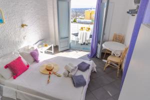 a bedroom with a bed with a view of the ocean at Smarula Villa in Firostefani