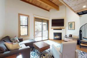 a living room with a couch and a fireplace at Sockeye by AvantStay Modern 2 BR Condo w Access to Northstar Resort Community in Kingswood Estates
