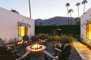 a patio with chairs and a fire pit in a yard at Hotel El Cid by AvantStay 16 OCC Full Hotel Buyout in Palm Springs w Pool in Palm Springs