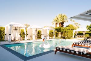 a swimming pool with a swan in the middle at Hotel El Cid by AvantStay 16 OCC Full Hotel Buyout in Palm Springs w Pool in Palm Springs