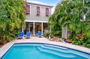 a house with a swimming pool in front of a house at Amelia Home by AvantStay In Historic Old Town w Pool in Key West