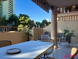 a table and chairs on the balcony of a building at La Promenade in Benicàssim