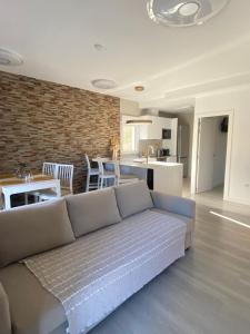 a living room with a couch and a kitchen at The Bridge house of Toledo in Toledo