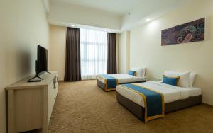 Zecon Hotel HPKK في كوالالمبور: غرفة فندقية بسريرين وتلفزيون بشاشة مسطحة