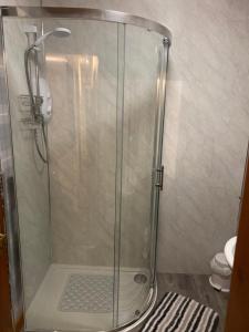 a shower with a glass door in a bathroom at Riverside in Tarbert