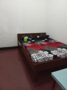 a bed in a room with a bedspread on it at K ADVENTURE HOMESTAY in Ketapang +8 photos