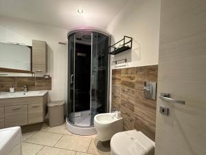 a bathroom with a shower and a toilet and a sink at NG Collection Piazza Castello in Sassari