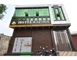 a hotel ra inn with motorcycles parked in front of it at Hotel Raj Inn, Agra in Agra