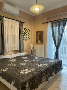 a bedroom with a large bed and a window at Villa Dani in Aigio
