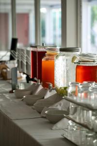 a row of jars and bowls on a table at Living Place Hotel in Villanova