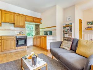 a living room with a couch and a table at 1 Bed in Aviemore 28823 in Nethy Bridge