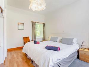 a bedroom with a large bed with two pillows on it at 1 Bed in Aviemore 28823 in Nethy Bridge