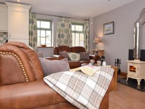 a living room with a couch and a wood stove at 1 Bed in Durham HISHO in Lanchester
