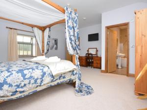 a bedroom with a canopy bed and a bathroom at 1 Bed in Durham HISHO in Lanchester