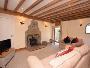 a living room with a couch and a fireplace at 3 Bed in Ashford in the Water PK501 in Great Longstone