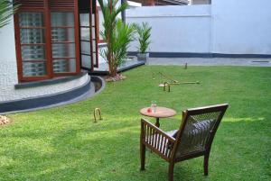 une table et une chaise assises dans une cour dans l'établissement "27" Spathodea- Oasis in the City, à Colombo