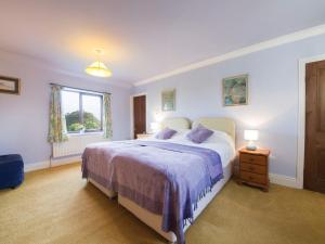 a bedroom with a large bed and a window at 2 Bed in Holmesfield PK783 in Dronfield