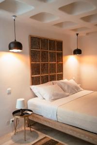 a bedroom with a white bed with two lights at Luxury Sunset in Mýkonos City