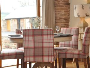 a dining room with a plaid dining room table and chairs at 3 Bed in Leominster 50507 in Pencombe