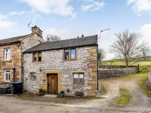 an old stone house in the middle of a field at 2 Bed in Hartington 54214 in Hartington