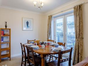 a dining room with a table and chairs and a window at 3 Bed in Brixham BX002 in Brixham