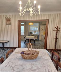 a dining room with a table with a basket on it at Gîte Le Cep de Bouzy in Bouzy