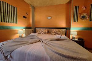 a bedroom with a large bed with two pillows at Gîte Le Cep de Bouzy in Bouzy