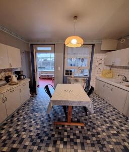 a kitchen with a table and chairs in it at Gîte Le Cep de Bouzy in Bouzy