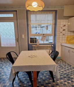 a table with a checkered table cloth on it in a kitchen at Gîte Le Cep de Bouzy in Bouzy