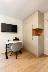 a room with a desk and a tv on a wall at Urban Studios near Iulius Mall in Cluj-Napoca