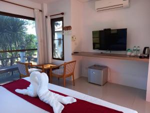 a hotel room with a bed with a towel on the floor at Phuphamok Valley Resort in Ban Na Dan