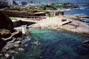 an aerial view of a beach with chairs and the water at Barford Haven in Hermanus