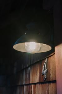 une lampe suspendue au-dessus d'un mur en bois avec dans l'établissement 2403 - Oak Knoll #4 cabin, à Big Bear Lake