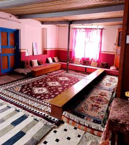 a living room with a couch and a table at Nawang HomeStay in Kaza