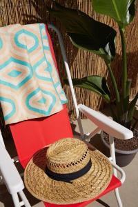 a straw hat sitting on a chair next to a plant at 2404 - Oak Knoll Studio #5 cabin in Big Bear Lake
