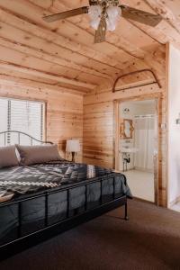 een slaapkamer met een bed en een plafondventilator bij 2408 - Oak Knoll ADA Studio #10 cabin in Big Bear Lake