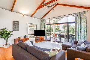 a living room with two couches and a television at Footsteps By The Bay in Dunsborough