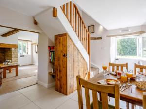 a kitchen and dining room with a table and a staircase at 1 Bed in Bedford 79095 in Turvey