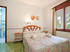a bedroom with a bed with towels on it at 0328 Apartment in Calella de Palafrugell in Calella de Palafrugell