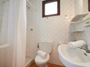a bathroom with a toilet and a sink and a tub at 0328 Apartment in Calella de Palafrugell in Calella de Palafrugell