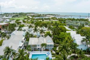 an aerial view of a resort with a pool and palm trees at Conch Adventure by AvantStay Great Location w Patio Outdoor Dining and Shared Pool Week Long Stays in Key West