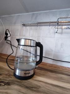 a tea kettle on a counter with water in it at Xata 1+2 in Almaty