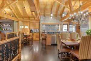 a kitchen and dining room with a table and chairs at Moose Lodge by AvantStay Luxe Berkshires Escape in North Egremont