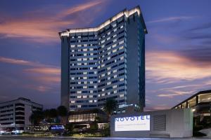 a large building with a sign in front of it at Novotel Singapore on Kitchener in Singapore