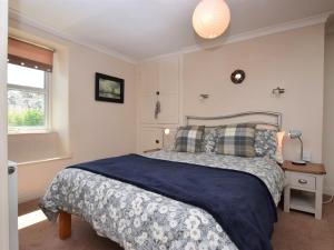 a bedroom with a large bed and a window at 1 bed in Brixham BX046 in Brixham